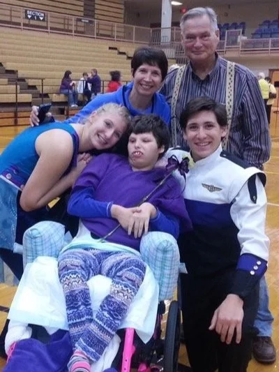 Bailey surrounded by her family at a sporting event