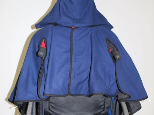 A blue Bailey Bug coat fitted around a wheelchair