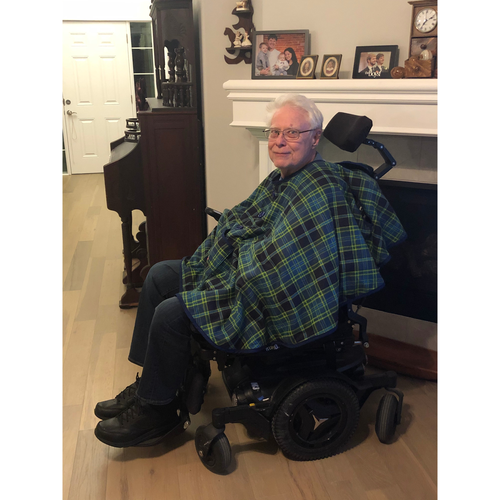 A wheelchair user wearing a green plaid Bailey Bug coat